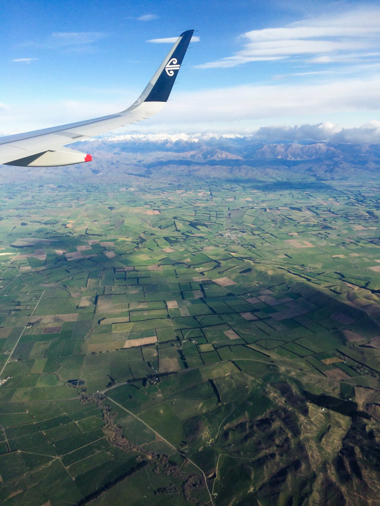 Flat pastures in the Canterbury region, bordered by the Southern Alps