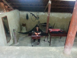 A hired actress sewing.