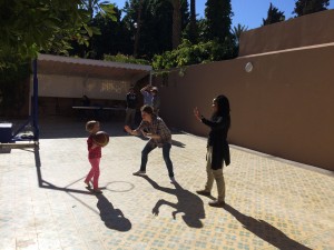 Lesedi and Emma take a break from Derija to battle Beatrix in a heated game of basketball.